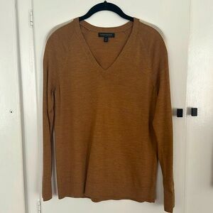 Tan v-neck sweater with white stripe along the sleeve. Banana Republic, Size M